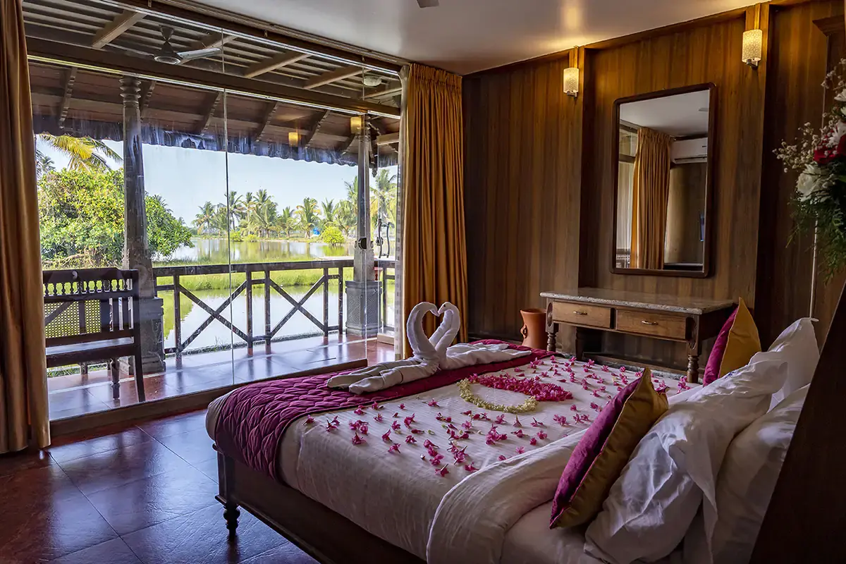 Super Deluxe Room with the backwater visible from the bed through the balcony
