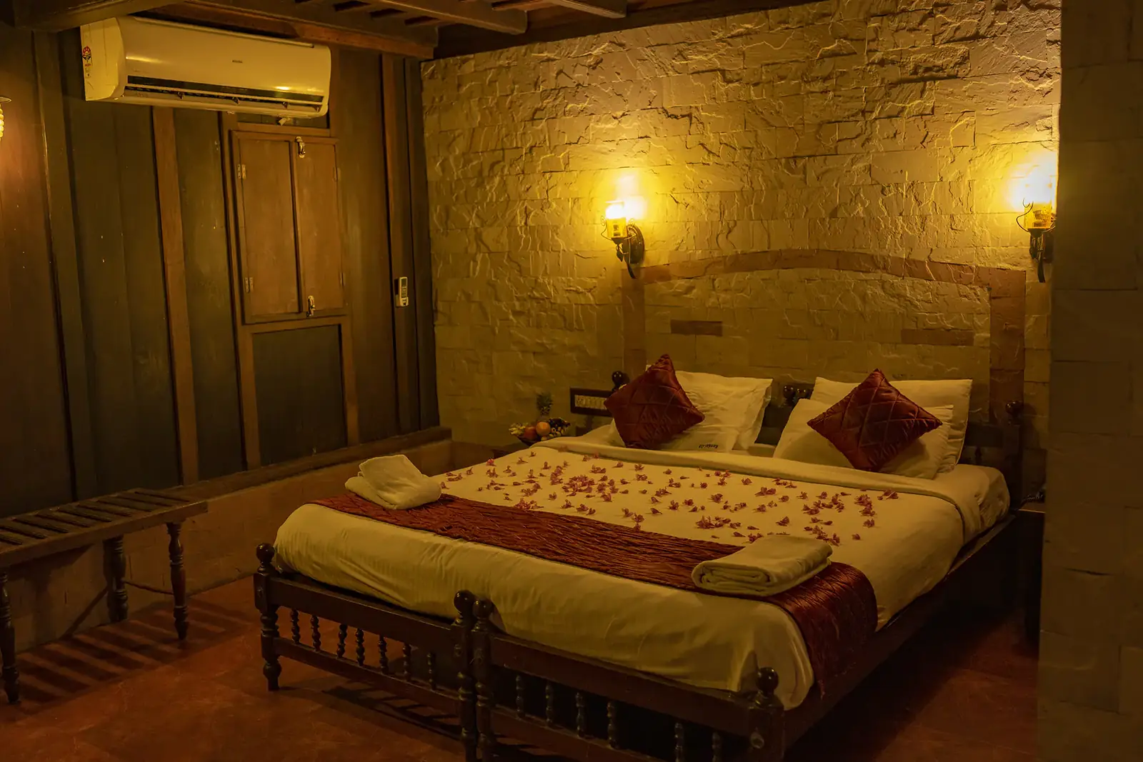 King bed under warm wall lamps in the Deluxe Heritage Room