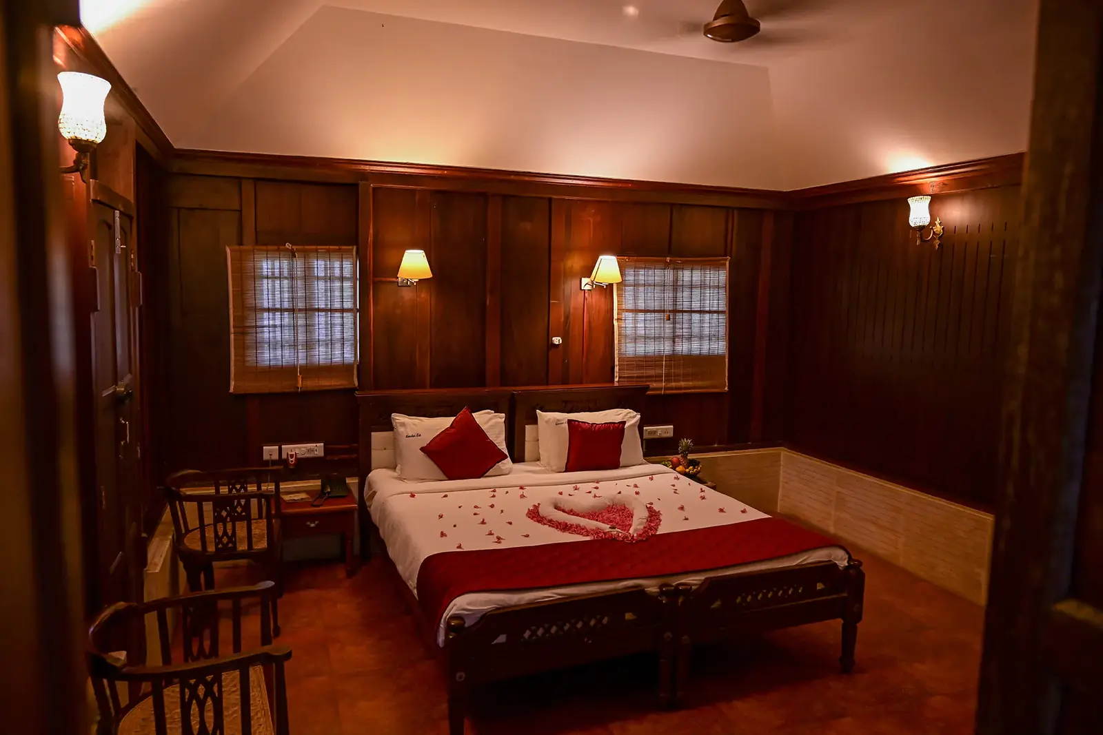 Wood-panelled Super Deluxe Cottage bedroom with king bed