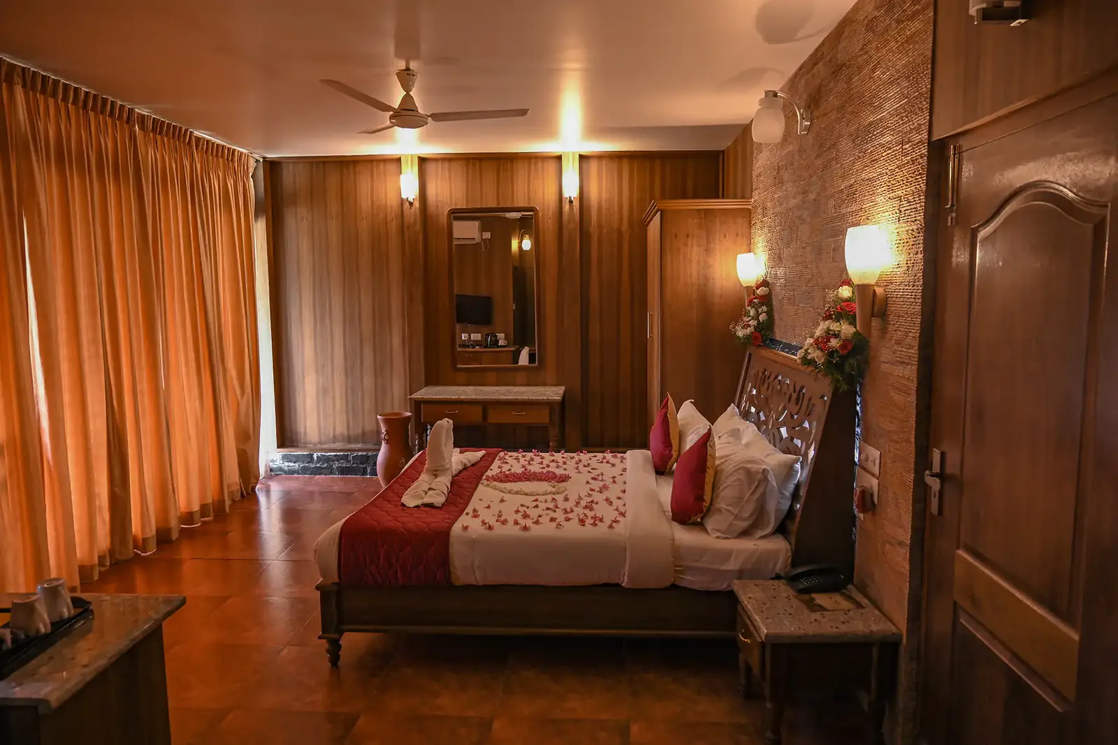 Super Deluxe Room bedroom with carved headboard